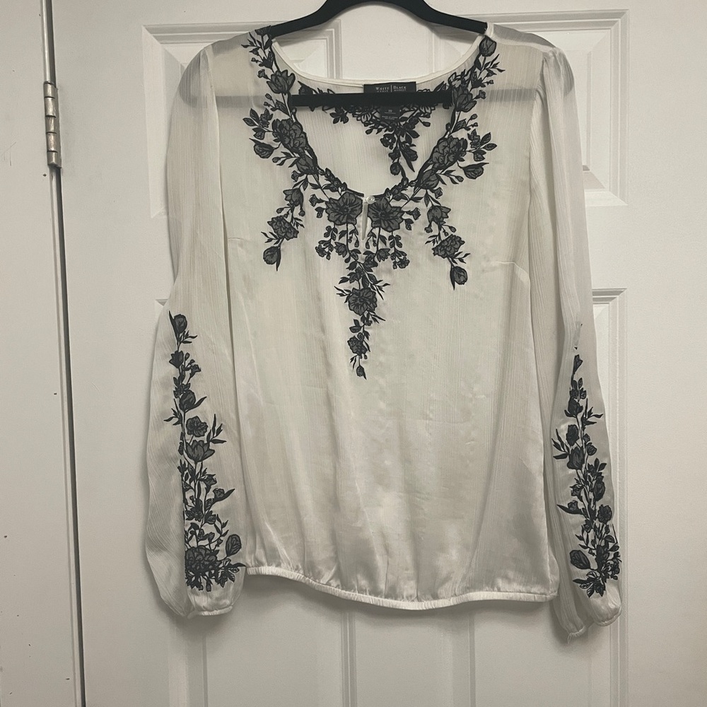 White House, Black market white sheer blouse was black embroidered flowers.